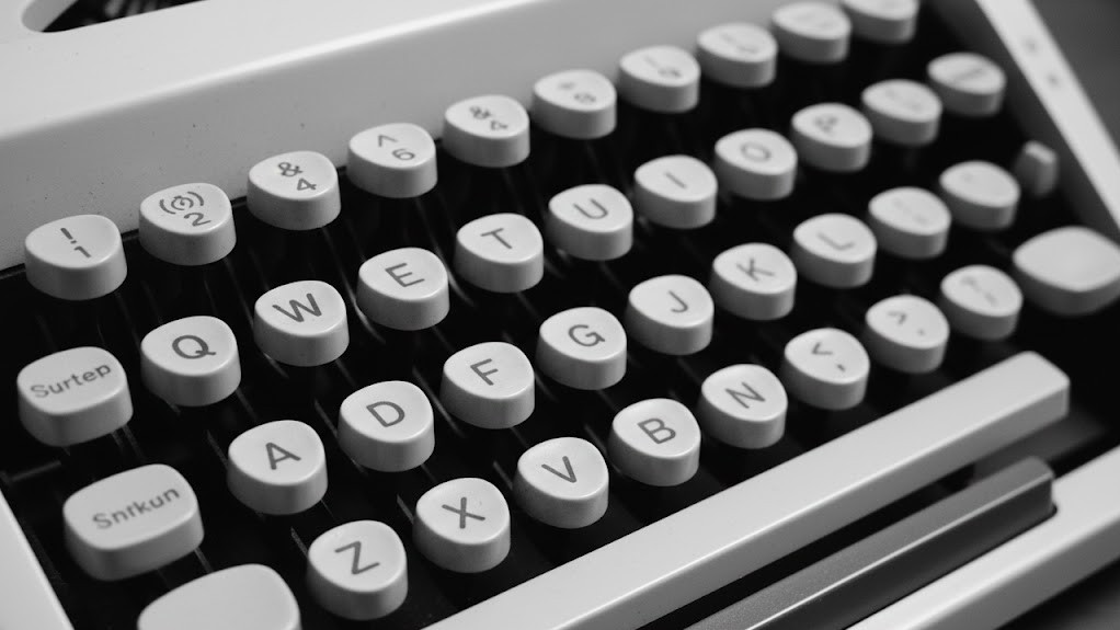 Close-up of a retro typewriter keyboard with round keys